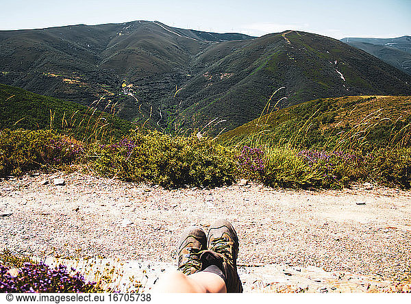 legs in boots hanging in a forest mountains landscape