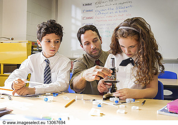 Lehrer hilft Schülern beim wissenschaftlichen Experiment im Labor
