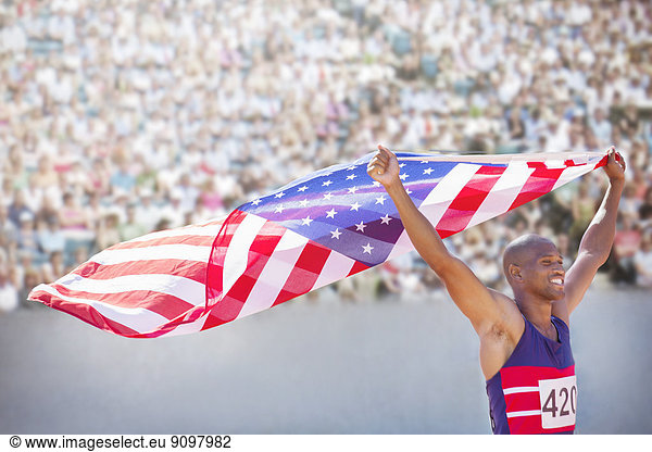 Leichtathlet mit amerikanischer Flagge im Stadion