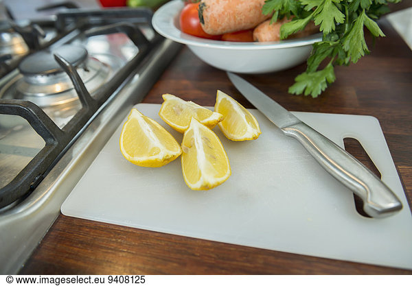 Lemon slices on chopping board with knife  close up