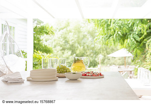 Lemonade and grapes on summer patio table