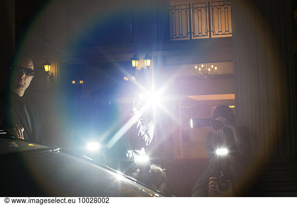Lens flare from paparazzi photographing at event