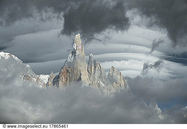 Lenticular clouds forming behind the misty peaks of Cerro Torre.