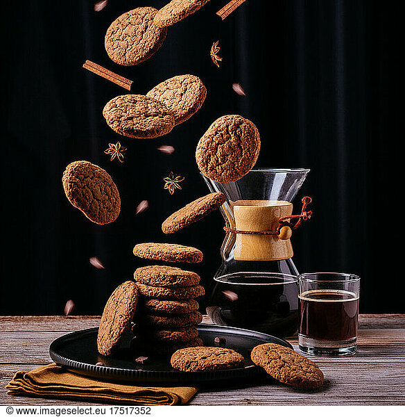 Levitating oatmeal cookies  coffee  black background