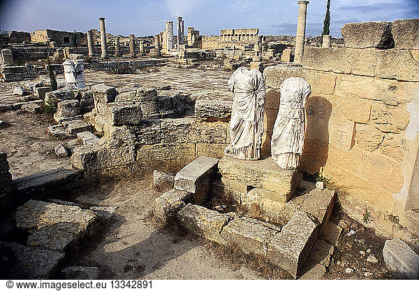 LIBYA Cyrenaica Cyrene Agora. Ruins of public square with two decapitated and armless statues in the foreground.
