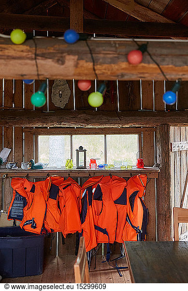 Life jackets hanging on wood in cabin