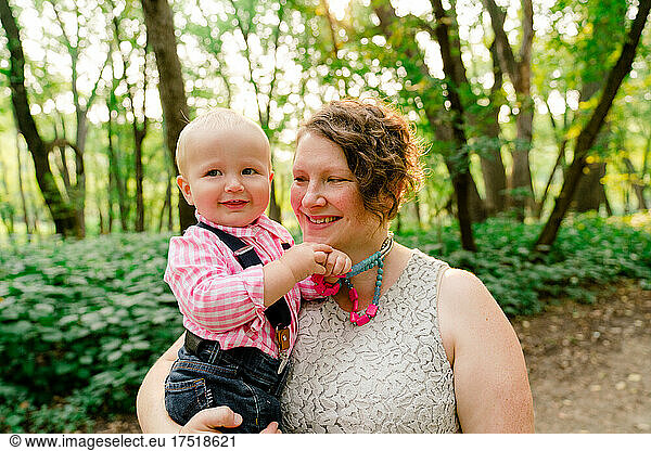 Lifestyle portrait of a mother holding her baby boy
