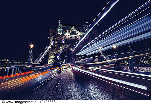 Light trails at Tower Bridge against clear sky at night