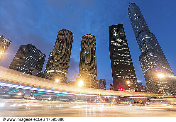 Light trails by illuminated buildings at night  Chicago  USA