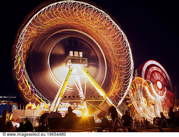 Light trails from amusment park rides at Calgary Stampede