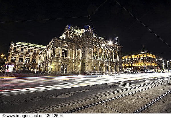 Light trails on road by Vienna State Opera against sky at night