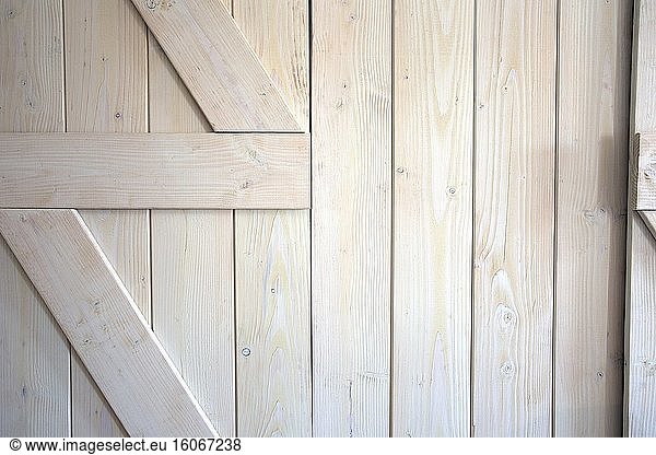Light wood barn doors background texture modern interior close-up retro design.