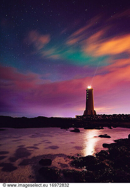 Lighthouse in Akranes Iceland with colorful clouds and northern lights