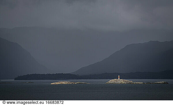 lighthouse on a small island in the Patagonian fjords