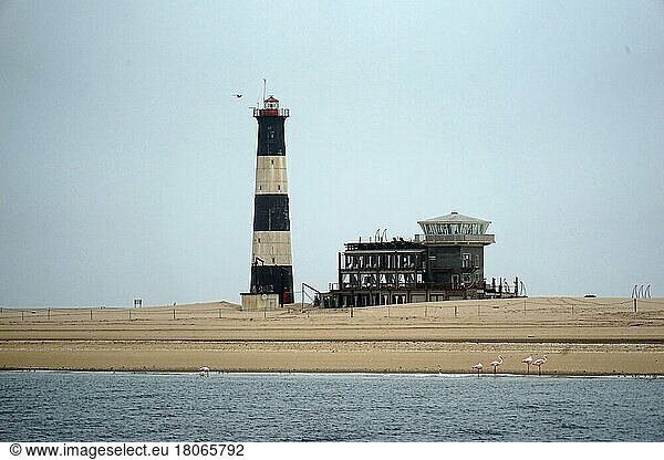 Lighthouse  Pelican Point  next to it control building of the port authority  Walvis Bay  Republic of Namibia