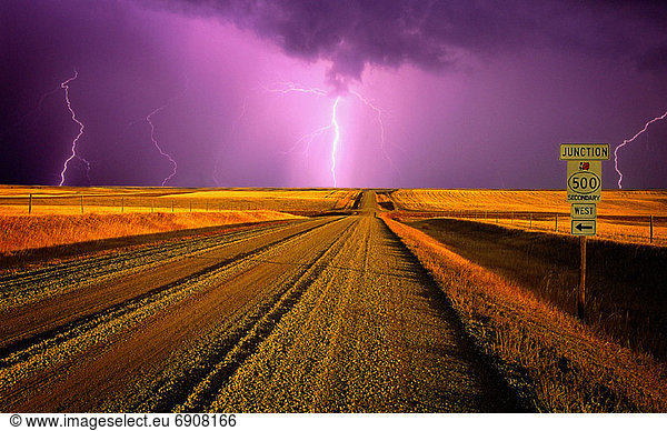 Lightning Over Dirt Road and Landscape  Near Milk River  Southern Alberta  Canada