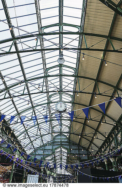 Lights and bunting decoration hanging from ceiling at railroad station