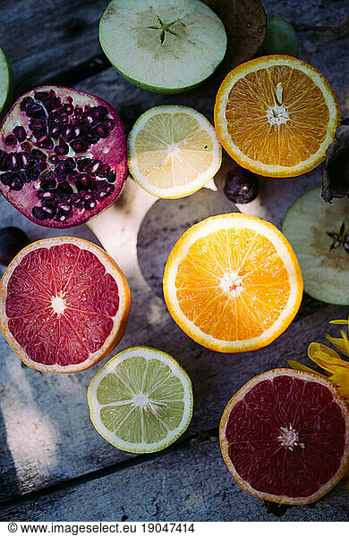 lime  pomegranate  red and natural orange on the rustic table.