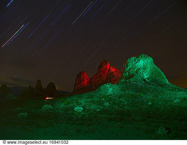 Lit up rock formations at night.
