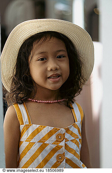 Little Asian girl in a straw hat