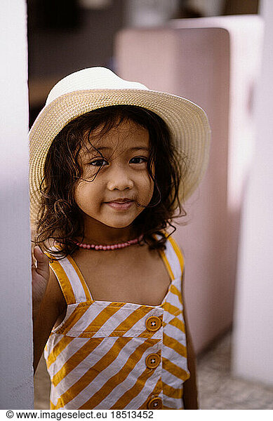 Little Asian girl in a straw hat