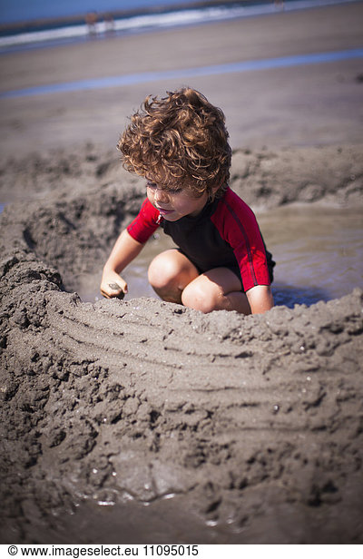 Little boy building a sandcastle in sand on the beach  Viana do Castelo  Norte Region  Portugal