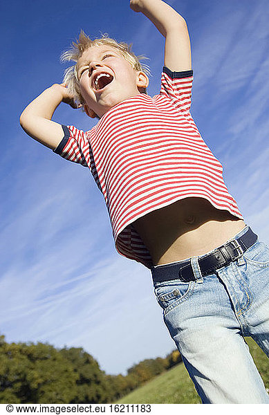 Little boy (4-5) fooling about  low angle view
