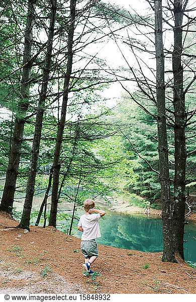 Little boy looking toward the pond.