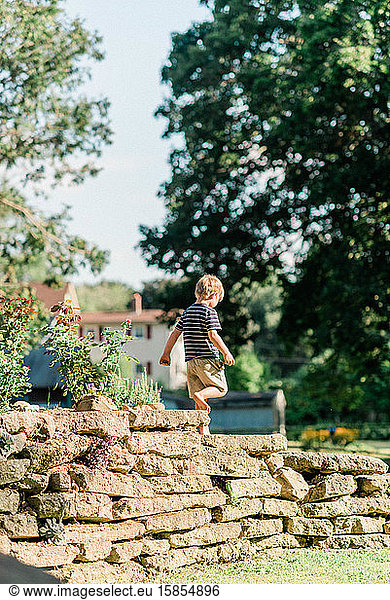 Little boy playing in a backyard.