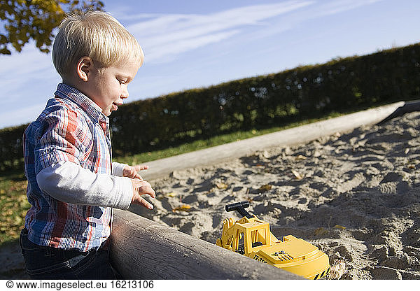 Little boy (2-3 playing in sandpit