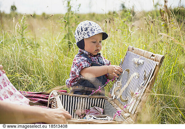 Little boy playing with basket in the countryside  Bavaria  Germany