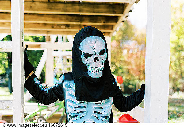 Little boy wearing a skeleton halloween costume