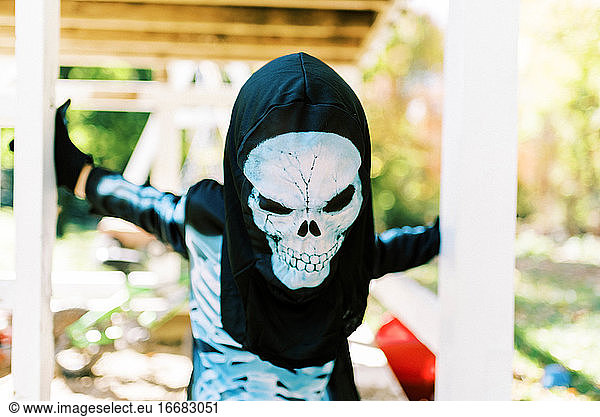 Little boy wearing a skeleton halloween costume