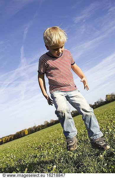 Little boy (4-5 years) playing in the meadow