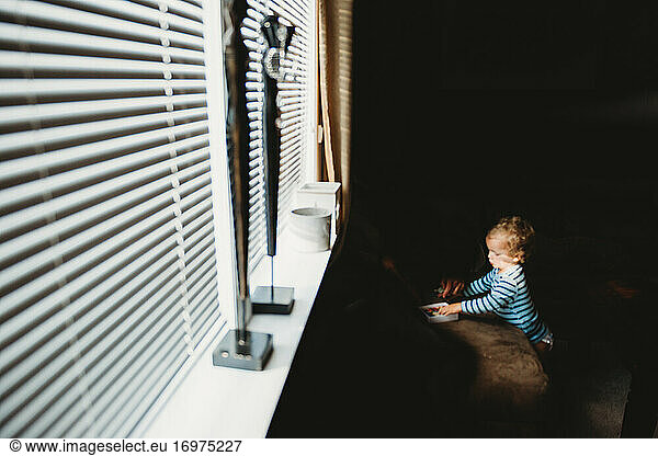 Little child playing alone during quarantine times due to covid