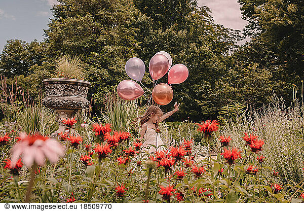 Little girl celebrating her birthday with balloons