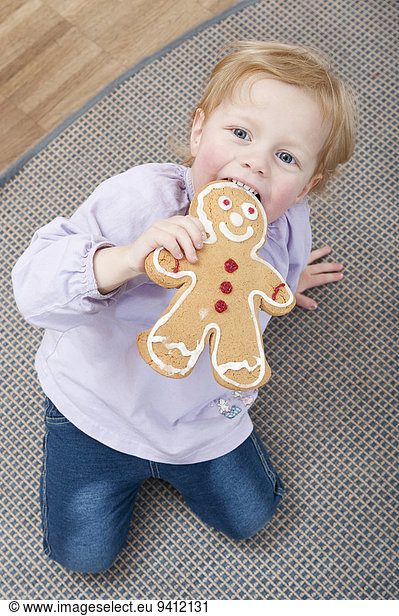 Little girl holding gingerbread man