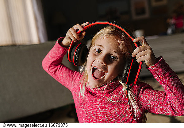 Little girl singing with headphones on
