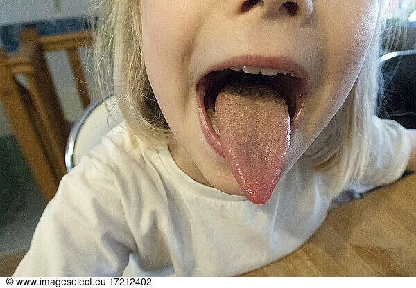 Little girl sticking out her tongue