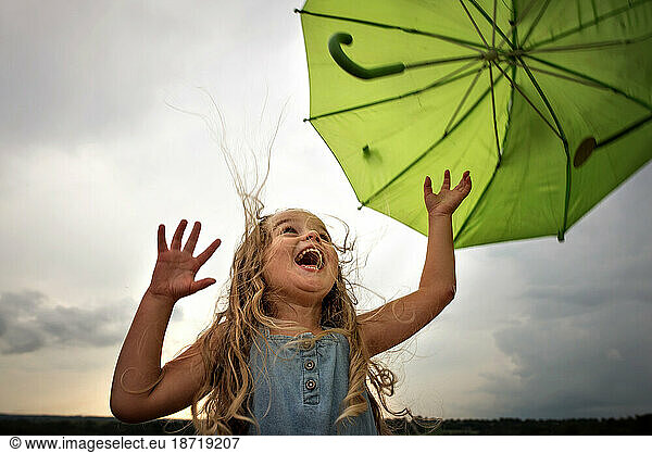Little girl with umbrella and big smile