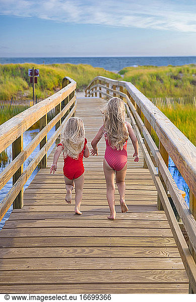 Little Girls From Behind Running On Bridge to Beach