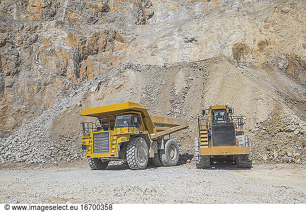 loader loading mining truck at open pit