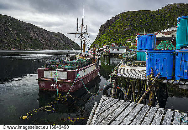 Lobster boat in small ocean fjord village in Newfoundland
