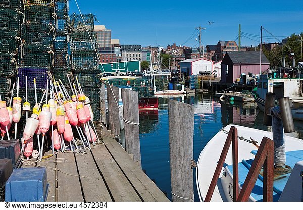 Lobster traps and float bouys stacked on wharf in Portland  Maine