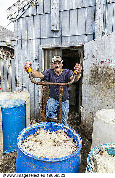 Lobsterman Al Stone  moving bait into storage at the Pine Point Fisherman's Co-op in Scarborough  Maine.