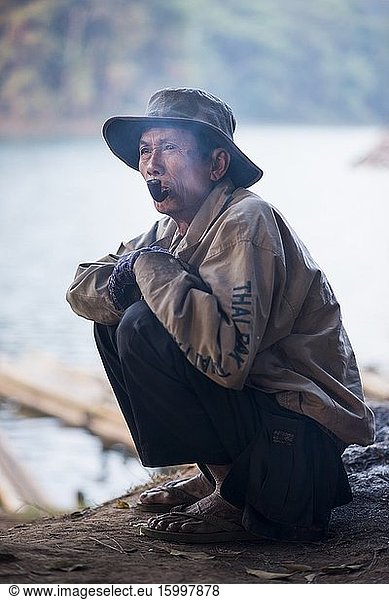 Local Bamboo raft driver smoking a pipe while waiting for costumers at the Pang Ung  Mae Hong Son  Thailand.