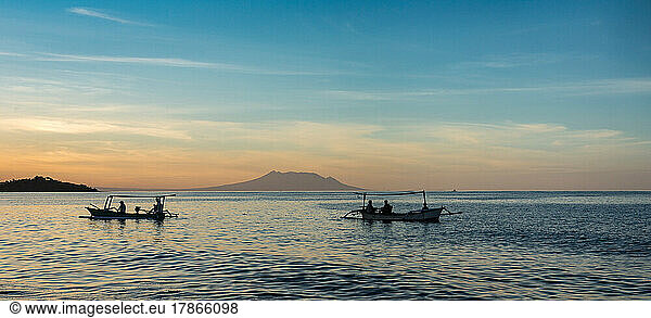 Local fishermen in their boat in Bali at sunset