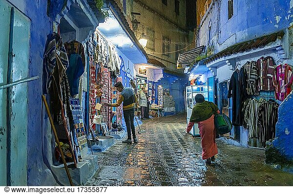 Locals in an alley with souvenir shops  blue houses  Chefchaouen medina  Chaouen  Tangier-Tétouan  Morocco  Africa