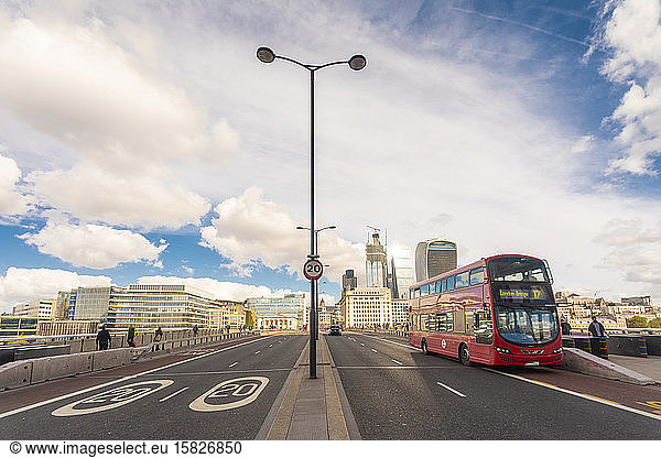 London bridge with the city of london and a double decker