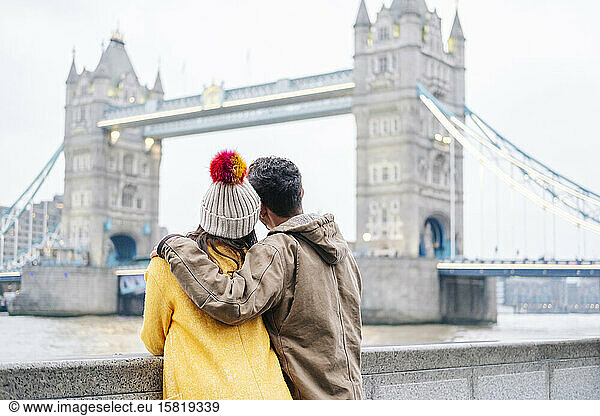 London  United Kingdom  Couple looking at Tower bringe with arms around